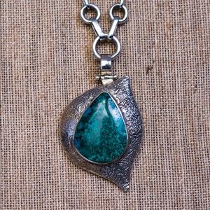 Handmade clasp pendant in .950 Sterling silver.